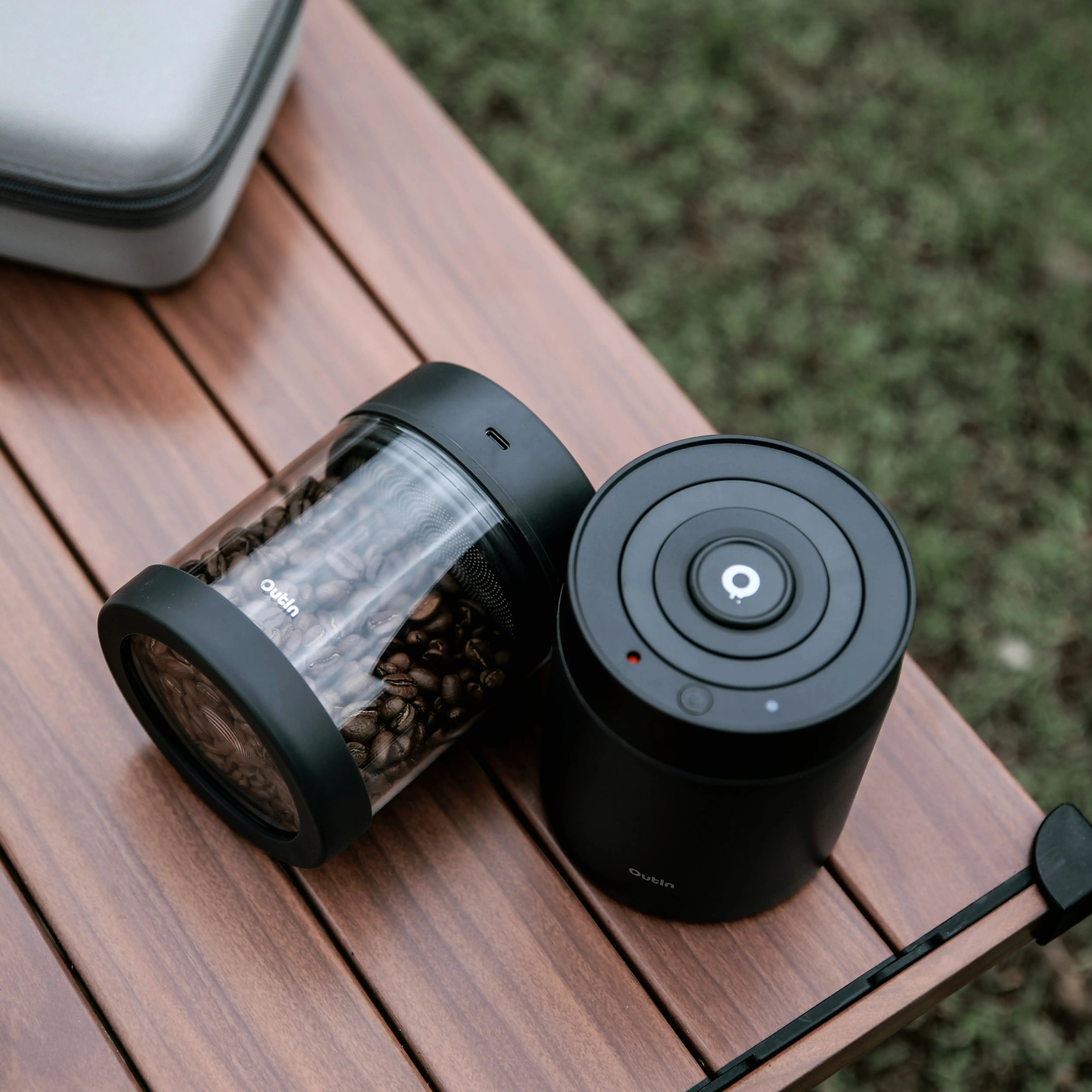 Outin Portable Electric Vacuum Coffee Canister on wooden table.