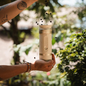 Person pouring coffee beans into Outin Fino portable grinder